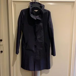 Raincoat with ruffle collar